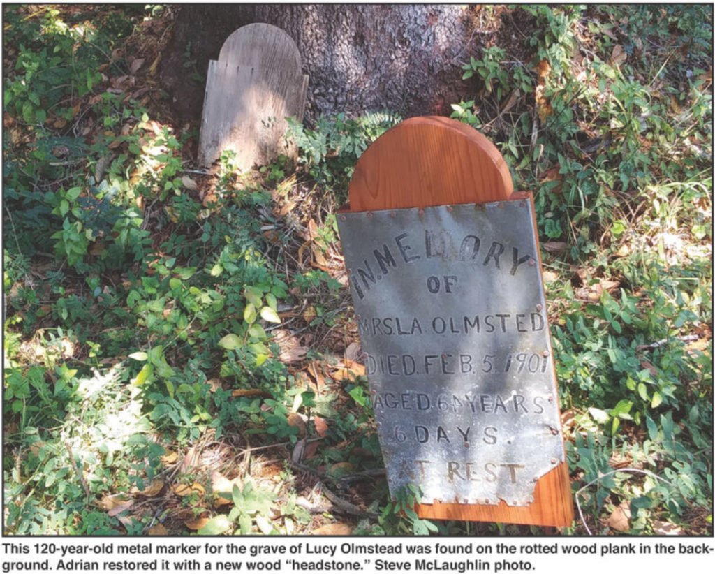 This 120-year-old metal marker for the grave of Lucy Olmstead was found on the rotted wood plank in the background.  Adrian restored it with new wood "headstone." Steve McLaughlin photo.