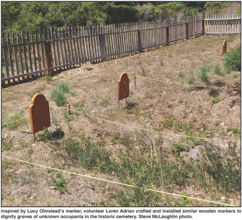 Inspired by Lucy Olmstead's marker, volunteer Loren Adrian crafted and installed similar wooden markers to dignity graves of unknown occupants in the historic cemetery. Steve McLaughlin photo.